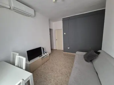 a small living room with a couch and a tv at Marry home in Barcelona