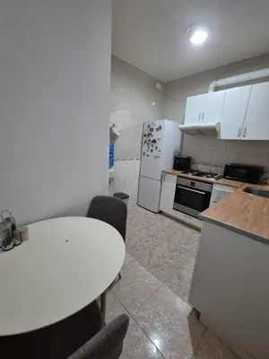 a kitchen with a white table and a white refrigerator at Marry home in Barcelona