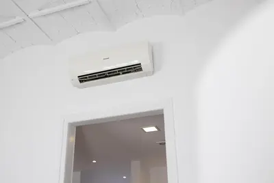 a ceiling fan in a room with a mirror at Stay U-nique Apartment Republica Argentina in Barcelona