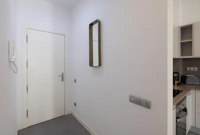 a kitchen with white cabinets and a sliding door at Stay U-nique Apartment Republica Argentina in Barcelona