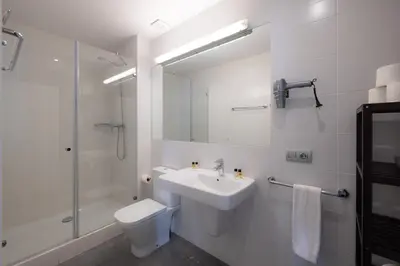 a bathroom with a sink and a toilet and a shower at Stay U-nique Apartment Republica Argentina in Barcelona