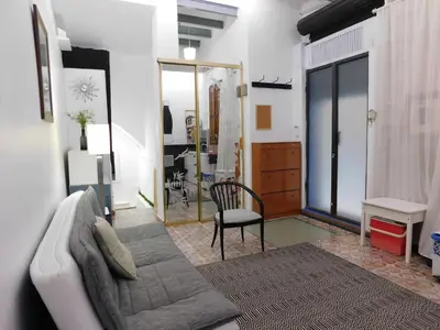 a living room with a couch and a chair at A pasos de la playa en Barcelona! in Barcelona