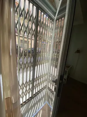an open glass door with a view of a street at Barcelona Home in Barcelona