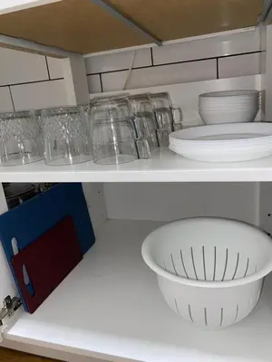 a white shelf with plates and bowls on it at Barcelona Home in Barcelona
