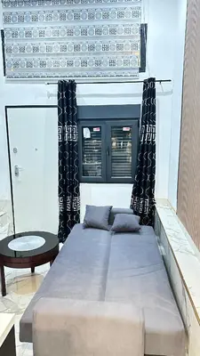 a small bedroom with a bed in a white room at Casa hamburg BCN in Badalona