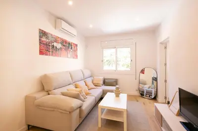 a living room with a couch and a tv at Lovely apartment with 3 bedroom in Cornellà de Llobregat