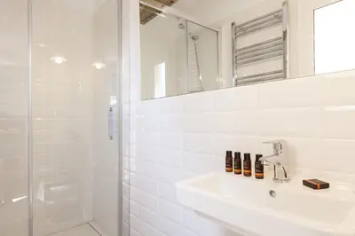 a white bathroom with a sink and a shower at Aspasios Charming Flats in Barcelona
