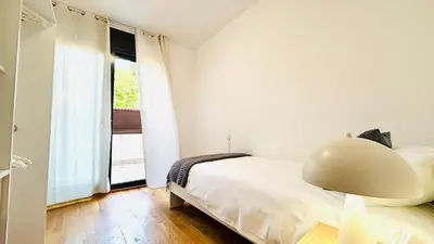 a bedroom with a bed with a helmet on it at Bajos con jardín in Terrassa