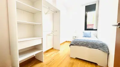 a bedroom with a bed and a closet at Bajos con jardín in Terrassa