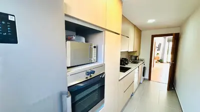 a kitchen with a sink and a microwave at Bajos con jardín in Terrassa