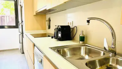 a kitchen with a sink and a counter top at Bajos con jardín in Terrassa