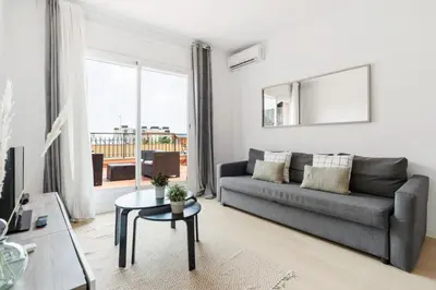 a living room with a couch and a table at Flateli Calàbria in Barcelona
