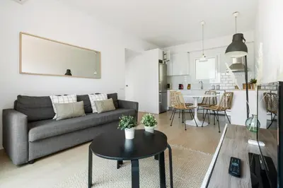 a living room with a couch and a table at Flateli Calàbria in Barcelona