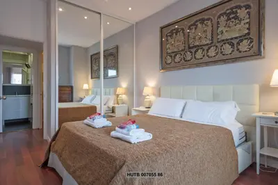 a bedroom with a bed with two babies on it at Alcam Augusta in Barcelona
