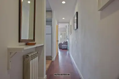 a hallway with a mirror and a radiator in a house at Alcam Augusta in Barcelona