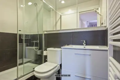 a bathroom with a toilet and a sink and a shower at Alcam Augusta in Barcelona