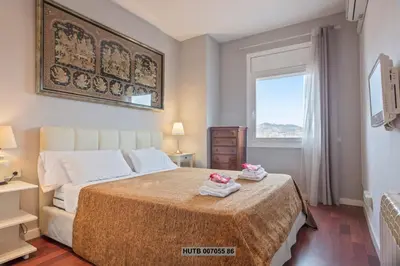 a bedroom with a bed with two towels on it at Alcam Augusta in Barcelona