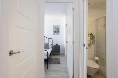 a bathroom with a toilet and a hallway at Bright & Stylish Flat In Trendy Grcia in Barcelona