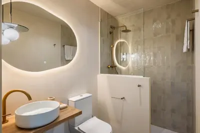 a bathroom with a sink and a toilet and a mirror at The Boulevard by Aspasios in Barcelona