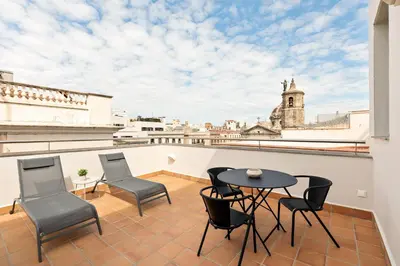 a balcony with a table and chairs and a view of the city at OLA LIVING - MT - Aire 1 in Barcelona