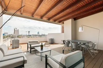 a living room with a table and chairs at OLA LIVING - MT - Aire 1 in Barcelona