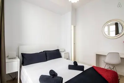 a bedroom with a white bed with two pillows on it at Housalia Ondina Suites Sagrada Familia in Barcelona