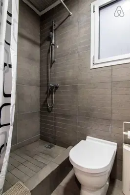 a bathroom with a toilet and a shower at Housalia Ondina Suites Sagrada Familia in Barcelona
