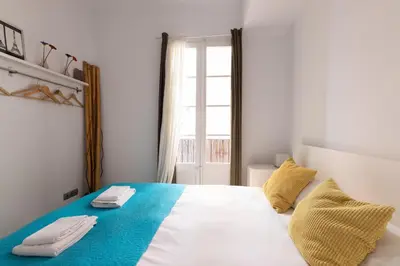 a bedroom with a bed with two towels on it at Housalia Ondina Suites Sagrada Familia in Barcelona