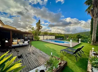 a backyard with a deck and a swimming pool at Villa Barcelona Experience Penedes Sitges Bliss with Private Pool in Can Trabal