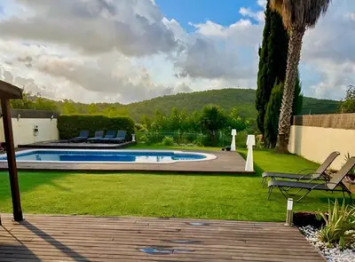 a backyard with a swimming pool and a lawn with chairs at Villa Barcelona Experience Penedes Sitges Bliss with Private Pool in Can Trabal