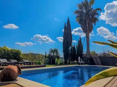 a swimming pool in a villa with palm trees at Villa Barcelona Experience Penedes Sitges Bliss with Private Pool in Can Trabal
