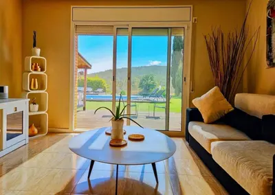 a living room with a couch and a table at Villa Barcelona Experience Penedes Sitges Bliss with Private Pool in Can Trabal