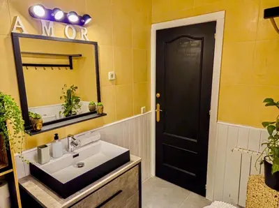 a bathroom with a sink and a black door at Villa Barcelona Experience Penedes Sitges Bliss with Private Pool in Can Trabal