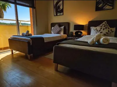 a bedroom with two beds and a large window at Villa Barcelona Experience Penedes Sitges Bliss with Private Pool in Can Trabal