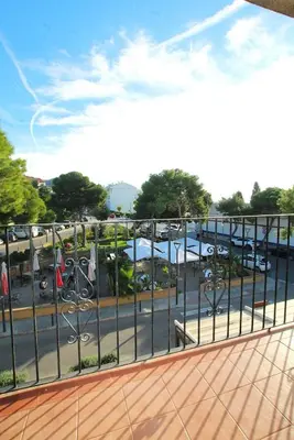 a balcony with a view of a parking lot at Quiet Apartment in Sitges Center Steps from Beach in Sitges