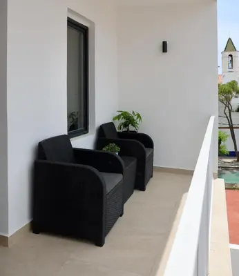 two chairs and a mirror on a wall at Quiet Apartment in Sitges Center Steps from Beach in Sitges