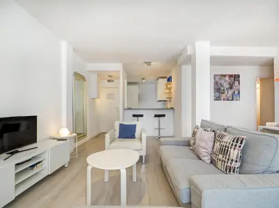 a living room with a couch and a table at Warm Sands Apartment by Hello Homes Sitges in Sitges