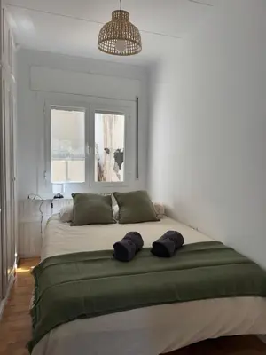 a bedroom with a large bed with two pillows on it at Vila Viva Mundo in San Cipriano de Vallalta
