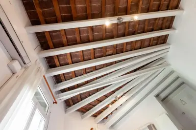 a view of the ceiling of a room with wooden ceilings at Urgell in Barcelona