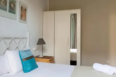 a bedroom with a white bed and a closet at Urgell in Barcelona