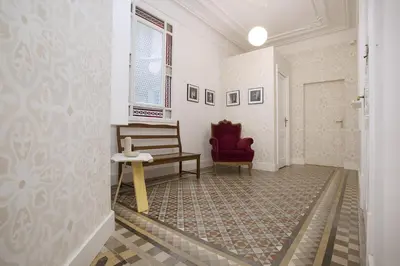 a hallway with a bench and a chair in a room at yök Casa Cultura in Barcelona