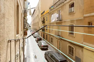 a view of a city street with cars parked at Lodging Apartments Almirall Beach 12 in Barcelona