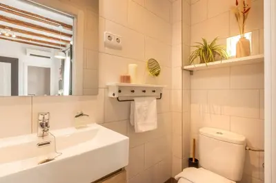 a white bathroom with a sink and a toilet at Lodging Apartments Almirall Beach 42 in Barcelona