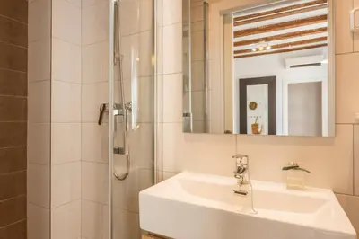 a bathroom with a sink and a shower at Lodging Apartments Almirall Beach 42 in Barcelona