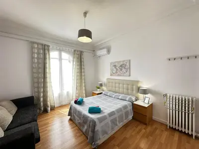 a bedroom with a bed and a flat screen tv at Gran Via Rooms in Barcelona