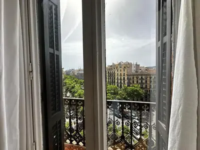 a bedroom with a bed with a blue object on it at Gran Via Rooms in Barcelona