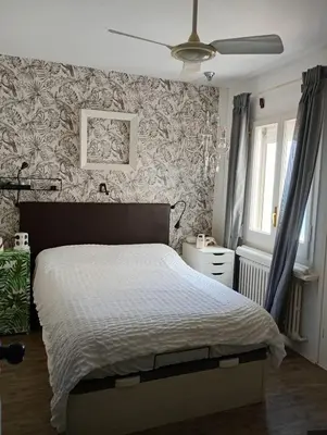 a bedroom with a bed and a ceiling fan at Frente al mar con Terraza - Sitges in Sitges