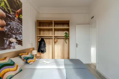 a bedroom with a bed and a painting on the wall at 4182 - AB Poble Sec - Plaza España X in Barcelona