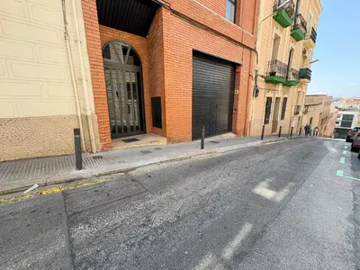 an empty street in front of a brick building at Stay U-nique Apartments at Albigesos in Barcelona