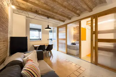 a living room with a couch and a table at Barcelona Touch Apartments - Font Honrada in Barcelona
